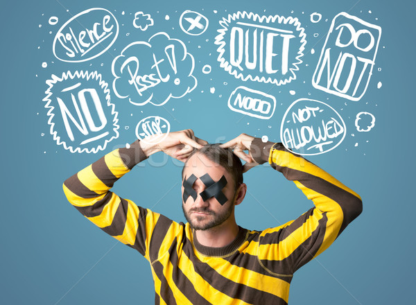 Young man with glued eye and thought clouds Stock photo © ra2studio