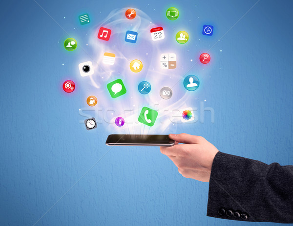 Hand holding tablet phone with app icons Stock photo © ra2studio