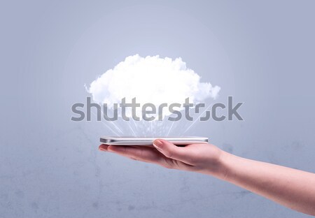 Hand holding phone with empty cloud Stock photo © ra2studio