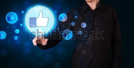 Handsome person pressing thumbs up button on modern social netwo Stock photo © ra2studio