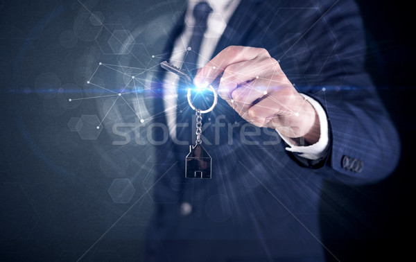 Man holding keys with connection concept Stock photo © ra2studio