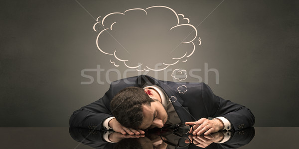 Businessman sleeping and dreaming at his workplace Stock photo © ra2studio