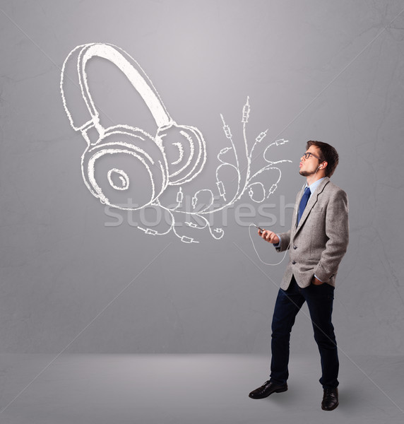 attractive man singing and listening to music with abstract headphone Stock photo © ra2studio