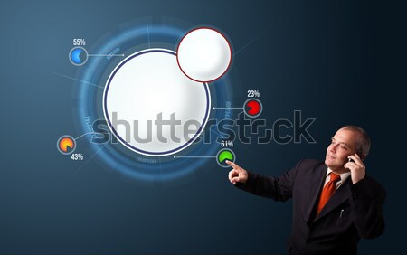 crazy businessman in suit holding a phone and presenting abstract modern pie chart Stock photo © ra2studio
