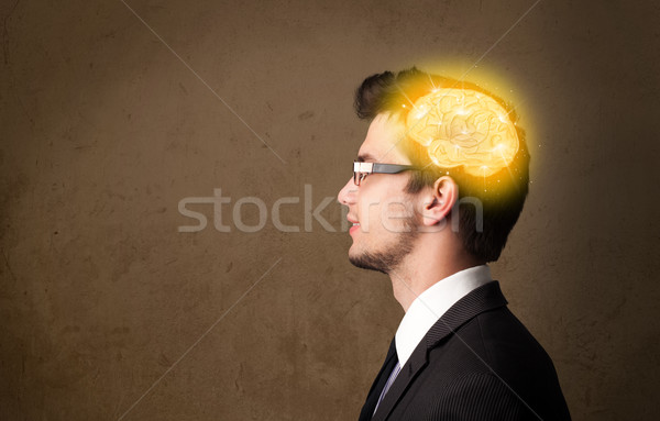 Young man thinking with glowing brain illustration Stock photo © ra2studio