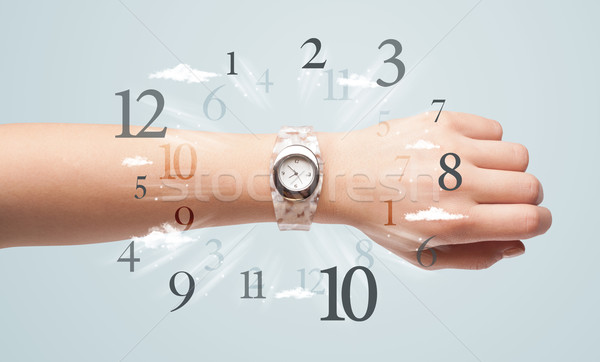 Hand with watch and numbers on the side comming out Stock photo © ra2studio