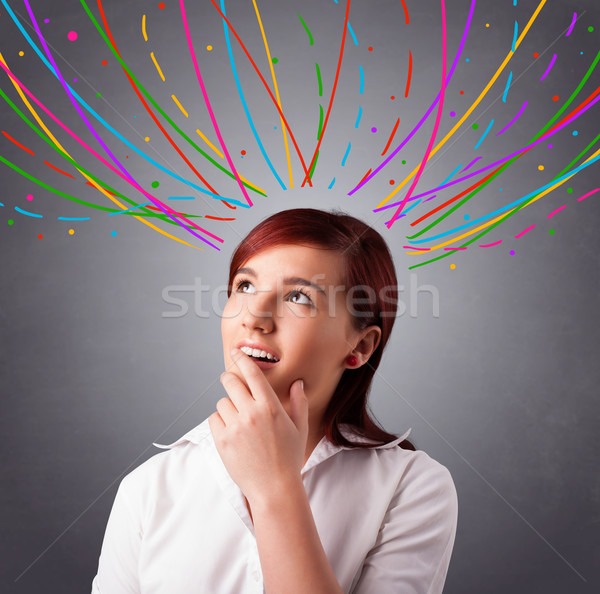 Young girl thinking with colorful abstract lines overhead Stock photo © ra2studio