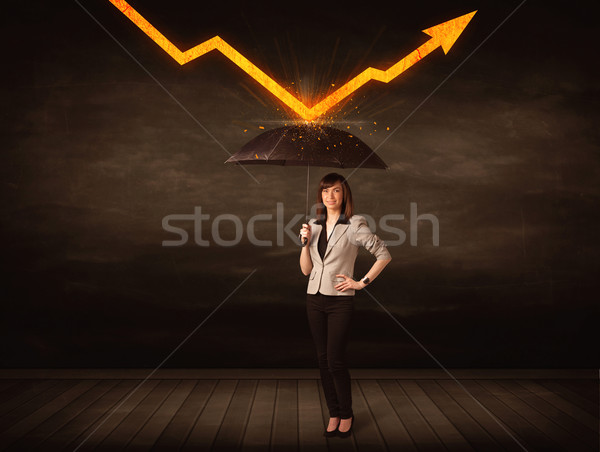 Businesswoman standing with umbrella keeping orange arrow  Stock photo © ra2studio