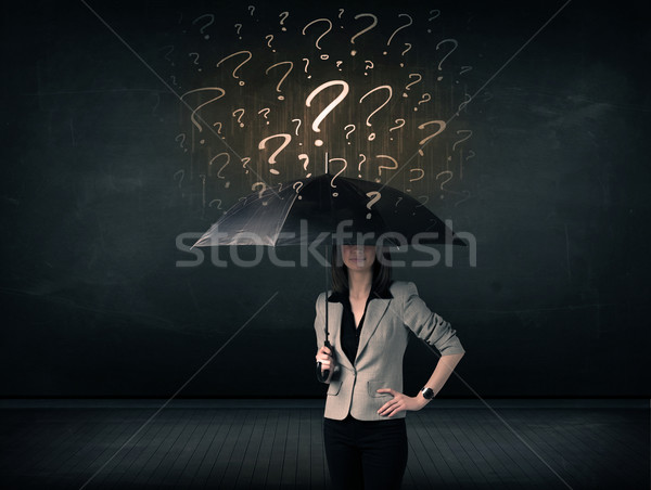 Businesswoman with umbrella and a lot of drawn question marks Stock photo © ra2studio