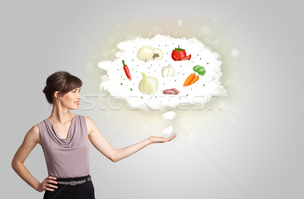 Pretty woman presenting a cloud of healthy nutritional vegetable Stock photo © ra2studio