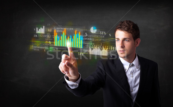 Young business person touching colorful charts and diagrams Stock photo © ra2studio