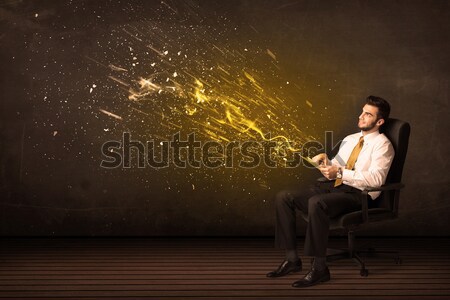 Businessman with tablet and energy explosion on background Stock photo © ra2studio