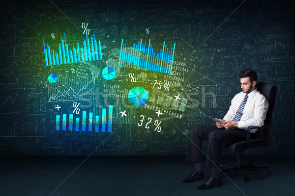 Businessman in office chair with tablet in hand and high tech gr Stock photo © ra2studio