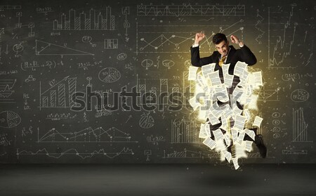 Stock photo: Handsome businessman jumping with paper document cloud