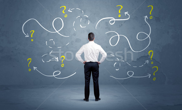 Unsure businessman with question marks Stock photo © ra2studio