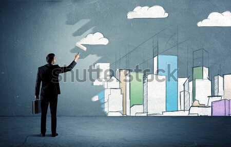 Salesman painting tall buildings on urban wall Stock photo © ra2studio