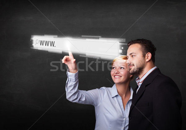 Young business couple touching web browser address bar with www  Stock photo © ra2studio