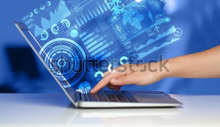 Modern notebook computer with future technology symbols Stock photo © ra2studio