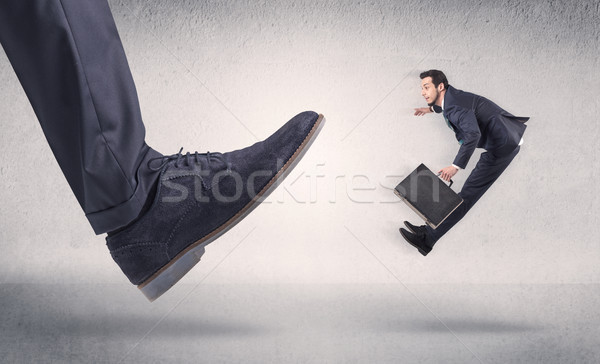 Small businessman kicked by big shoe Stock photo © ra2studio