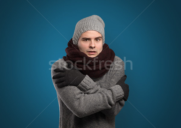 Handsome boy freezing in warm clothing Stock photo © ra2studio