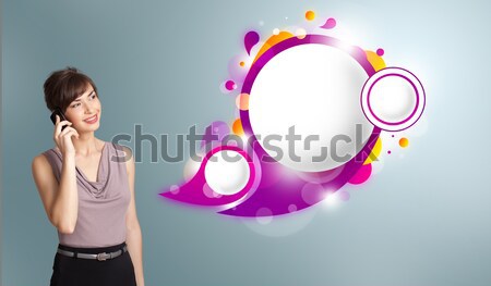 Pretty young woman presenting abstract speech bubble copy space and making phone call Stock photo © ra2studio