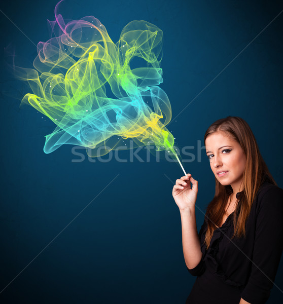 Pretty lady smoking cigarette with colorful smoke Stock photo © ra2studio