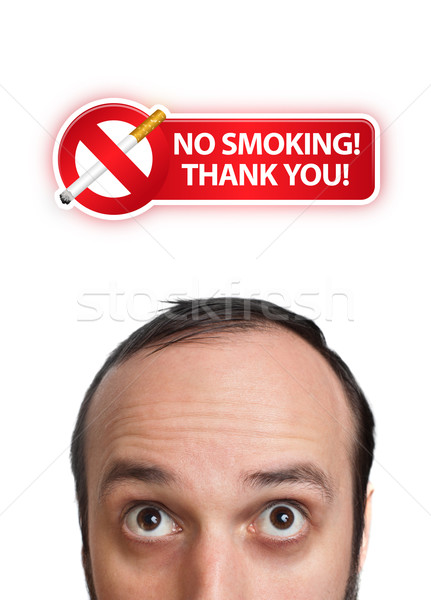 Young man with NO SMOKING sign over his head 2 Stock photo © ra2studio