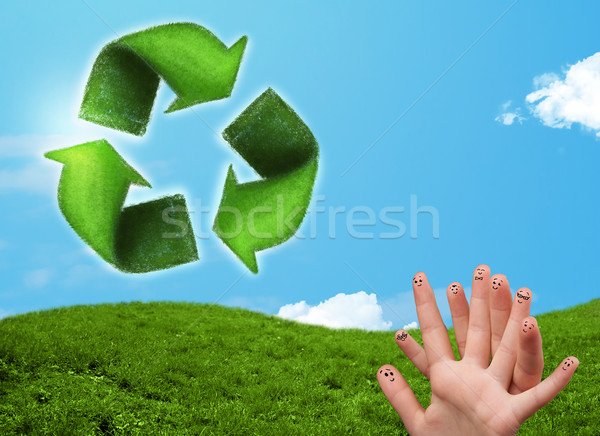 Happy smiley fingers looking at green leaf recycle sign Stock photo © ra2studio