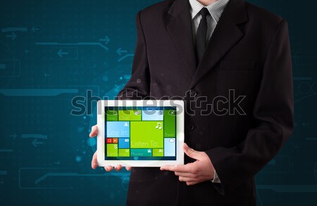 Young businessman holding a tablet with modern software operational system Stock photo © ra2studio