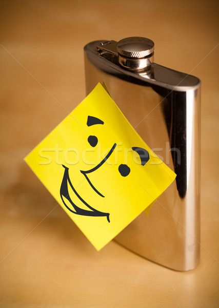 Post-it note with smiley face sticked on a hip flask Stock photo © ra2studio