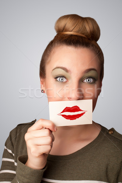 Happy pretty woman holding card with kiss lipstick mark Stock photo © ra2studio