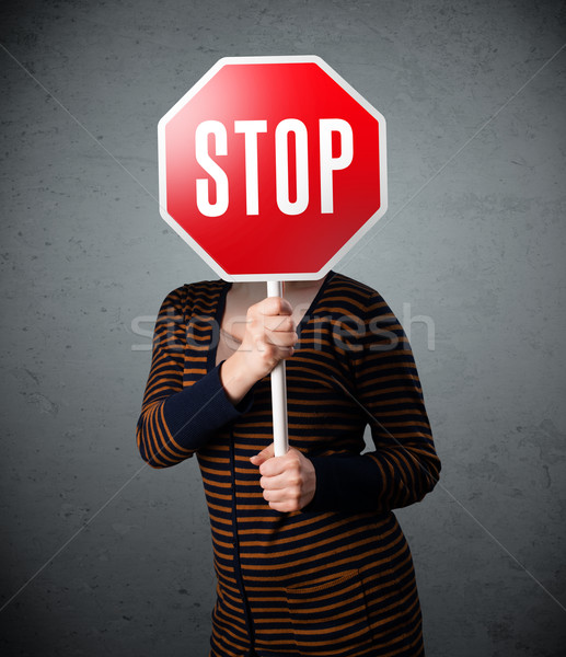 Young woman holding a stop sign Stock photo © ra2studio