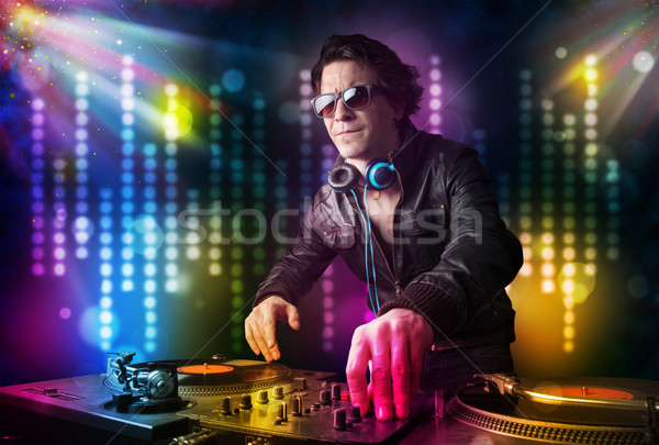 Dj playing songs in a disco with light show Stock photo © ra2studio