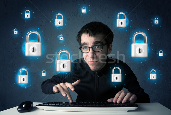 Young hacker with virtual lock symbols and icons Stock photo © ra2studio