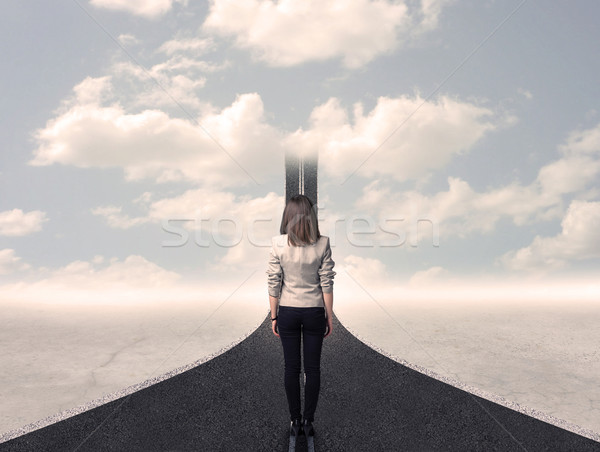 Business woman looking at road that goes up in the sky Stock photo © ra2studio
