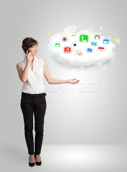 Young woman presenting cloud with colorful app icons and symbols Stock photo © ra2studio