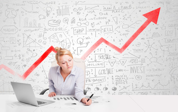 Business woman sitting at table with market diagrams  Stock photo © ra2studio