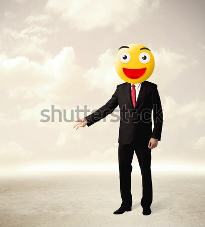 Stock photo: businessman wears yellow smiley face