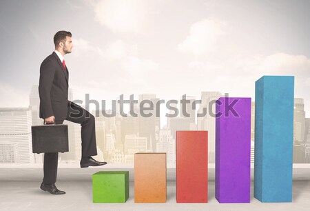 Uomo d'affari climbing up colorato grafico business Foto d'archivio © ra2studio