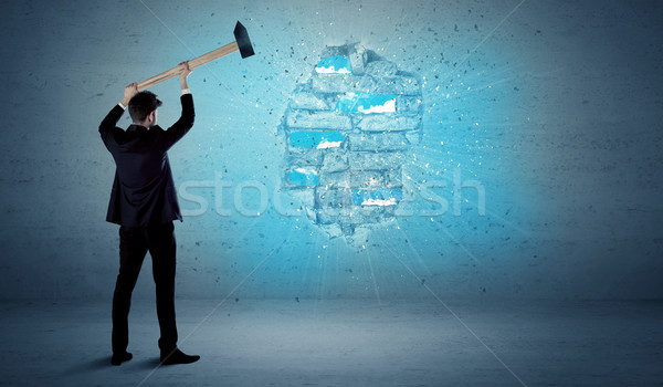 Business man hitting brick wall with huge hammer Stock photo © ra2studio