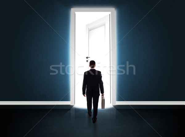 Business man looking at big bright opened door Stock photo © ra2studio