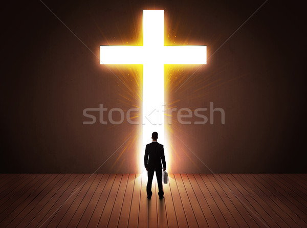Man looking at bright cross sign  Stock photo © ra2studio