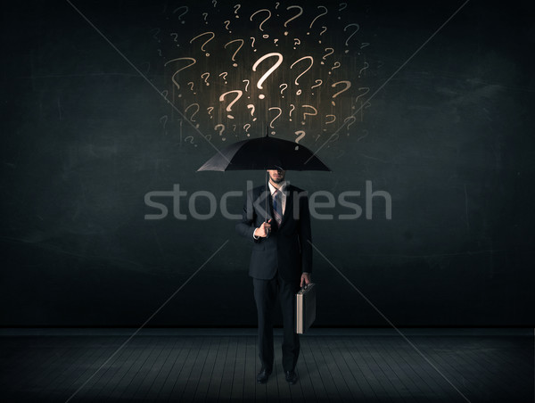 Businessman with umbrella and a lot of drawn question marks Stock photo © ra2studio