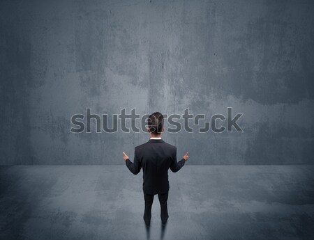 Salesman with roller standing at empty wall Stock photo © ra2studio