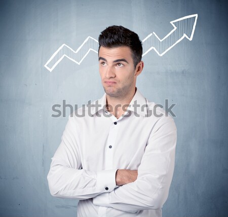 Smiling business guy with graph arrow Stock photo © ra2studio