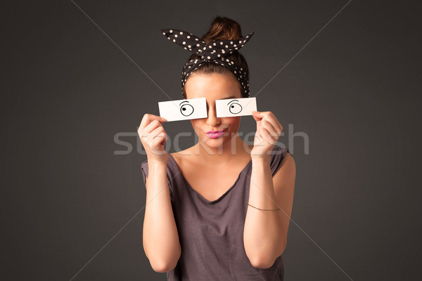 Young silly girl looking with hand drawn eye balls on paper Stock photo © ra2studio