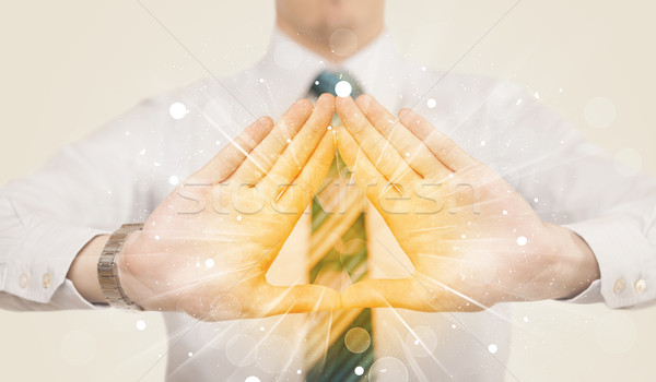 Stock photo: Hands creating a form with yellow shines