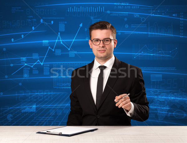 Stock data analyst in studio giving adivce on blue chart background Stock photo © ra2studio