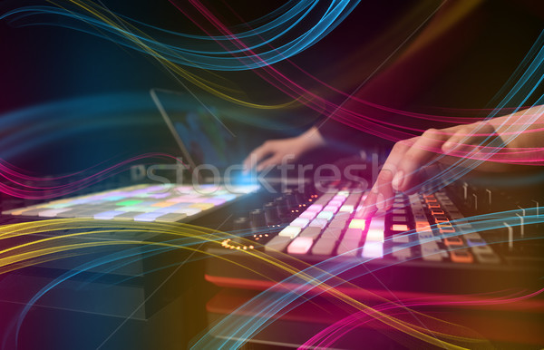 Hand mixing music on dj controller with colorful vibe concept Stock photo © ra2studio