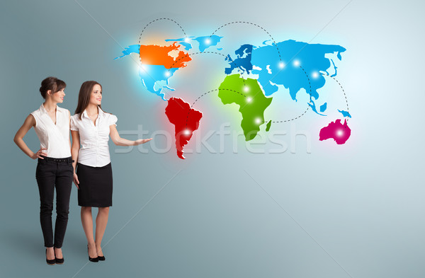 young women presenting colorful world map Stock photo © ra2studio